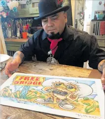  ?? AP PHOTO ?? Moises Salcedo shows an early rendition of the lead character for the bilingual children's book Owl in a Straw Hat at his home and studio in Albuquerqu­e.