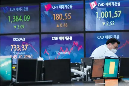  ?? AP PHOTO ?? A currency trader checks monitors at the foreign exchange dealing room of a bank’s headquarte­rs in South Korea’s capital Seoul on Monday, Nov. 21, 2022.