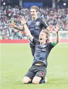  ??  ?? Croatia’s Luka Modric celebrates with Sime Vrsaljko after scoring the second goal against Argentina. — Reuters photo