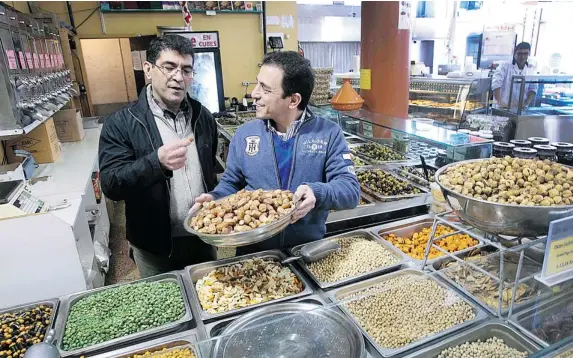  ?? MARIE-FRANCE COALLIER/ THE GAZETTE ?? “Our job is to serve the people, not to make money,” says Ali Ajabi, left, at the Sherbrooke St. W. location of Supermarch­é Akhavan with his brother Nasser.