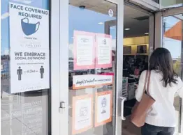  ?? LM OTERO/AP ?? A customer enters a Dallas store displaying a face mask-required sign March 2, the same day Texas Gov. Greg Abbott lifted the state’s mask mandate.