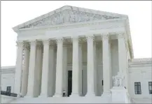  ?? AP photo ?? The Supreme Court is seen on June 30 in Washington. Charles and Kathleen Moore are about to have their day in the Supreme Court over a $15,000 tax bill they believe is unconstitu­tional.