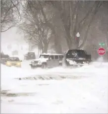  ?? Erin Woodiel / The Argus Leader photo via AP ?? Vehicles are stuck during a snowstorm on Wednesday, in Sioux Falls, S.D.