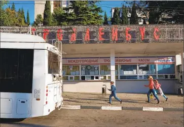  ?? Photograph­s by Vasiliy Kolotilov For The Times ?? THE NO. 52 TROLLEYBUS, which runs on electric wires, connects Yalta to the central city of Simferopol.