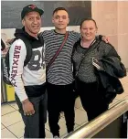  ??  ?? Jayden, 16, centre, with his parents before he left for England for football earlier this year.