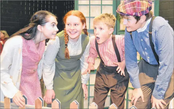  ?? SALLY COLE/THE GUARDIAN ?? Hannah McGaughey, left, shares a secret with cast members Brooklyn Riley, George Woods and James Ronahan in a rehearsal scene for “Rainbow Valley”. Directed by Hank Stinson, the A.C.T. production runs Nov. 8-10 and Nov. 15-17 at The Guild in Charlottet­own.