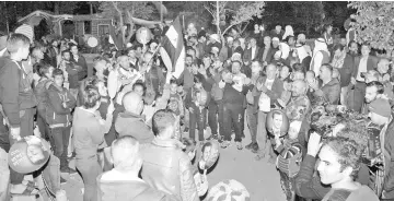  ??  ?? Photo shows people celebratin­g and waving the national flag in in the southern city of Sweida as they wait to welcome the recently freed hostages. — AFP photo