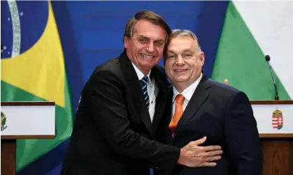  ?? Photograph: Attila Kisbenedek/AFP/Getty Images ?? Jair Bolsonaro hugs Hungary's prime minister, Viktor Orbán, right, in Budapest in 2022. ‘I won’t deny that I was in the embassy,’ he said on Monday.