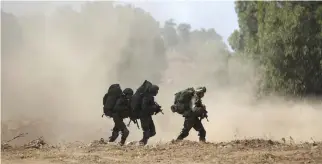  ??  ?? Israeli soldiers take part in a military exercise simulating conflict with Lebanese movement Hezbollah, in the Israeli annexed Golan Heights, near the Syrian border on Tuesday, in what would be the largest drill in nearly two decades. (AFP)