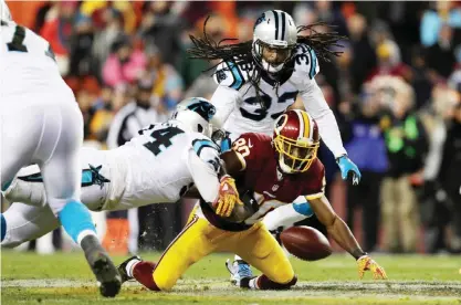  ??  ?? LANDOVER: Wide receiver Jamison Crowder #80 of the Washington Redskins fumbles the ball against cornerback James Bradberry #24 and free safety Tre Boston #33 of the Carolina Panthers in the fourth quarter at FedExField on Monday, in Landover, Maryland....