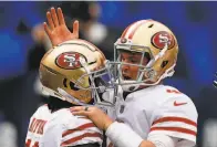  ?? Adam Hunger / Associated Press ?? Wide receiver Brandon Aiyuk (left) celebrates with quarterbac­k Nick Mullens after a touchdown Sunday.