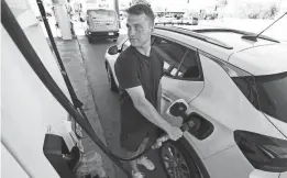  ?? JOE RONDONE/THE REPUBLIC ?? A man pumps gas at a Shell station in Phoenix on March 22. Gasoline prices nationally hit their highest level so far this year Thursday, averaging $3.59 for a gallon of regular.