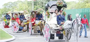  ?? (Ali Vicoy) ?? FLORES DE ERMITA — Young women or Sagalas riding a horse drawn carriage participat­e in the Flores De Ermita.