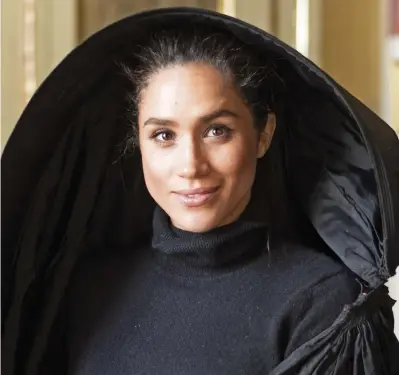  ??  ?? Cloak of secrets: Meghan wearing a traditiona­l ghonnella during her 2015 visit to the island