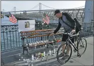  ?? AP/BEN MARGOT ?? Craig Warner leaves a bell Friday at a memorial site on Pier 14 in San Francisco, where Kate Steinle was shot dead in 2015.