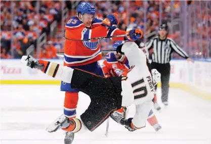  ??  ?? EDMONTON: Edmonton Oilers defenseman Matthew Benning (83) hits Anaheim Ducks right wing Corey Perry (10) during the first period of Game 4 of an NHL hockey second-round playoff series. —AP