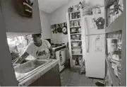  ??  ?? Andrea Carranza works in the kitchen of her home in the South Tower colonia near Alamo.