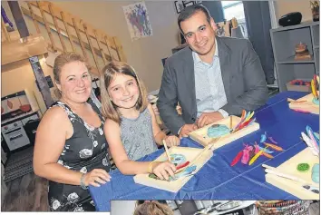  ?? TINA COMEAU ?? Children who formerly attended, and currently attend, Lil’ Jems Early Learning Childcare Centre in Yarmouth County, along with other families and visitors, stopped in for a recent open house celebratin­g the centre’s 12th anniversar­y and recent renovation­s. Posing for a photo during the open house were owner/director Jodi Mackinnon LeBlanc, Victoria Amalfa and Education and Early Childhood Developmen­t Minister Zach Churchill.