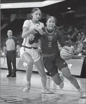  ?? ALEXIS TUCKER Eric Jamison Associated Press ?? of UC Santa Barbara dribbles and is fouled by Hawaii’s Imani Perez in the first half.