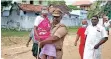  ?? ?? A cop helps an elderly woman to cast her ballot during second phase of polling at Sankarapur­am village