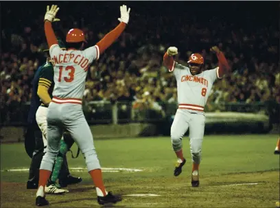  ?? PHOTO BY GETTY IMAGES ?? Cincinnati Reds’ Joe Morgan (8) heads for home plate as teammate Dave Concepcion (13) tells him not to slide during the World Series against the Oakland Athletics at Oakland-Alameda County Coliseum on October 1972 in Oakland.