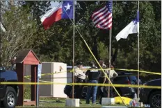  ?? WAGNER/AUSTIN AMERICAN-STATESMAN VIA AP ?? Law enforcemen­t officials stand next to a covered body at the scene of a fatal shooting at the First Baptist Church in Sutherland Springs, Texas on Sunday. NICK