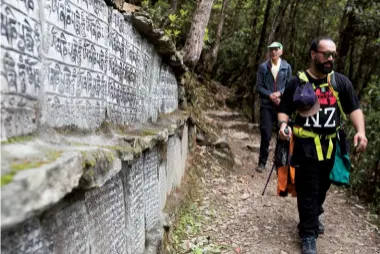  ??  ?? Below left: Mani stones: Trekking past Mani stones – rocks engraved with Buddhist mantras or prayers. The stones are found throughout the Everest region of Nepal and are instilled with profound spiritual significan­ce. Out of respect, people should always pass to the left of the stones. Credit: Blair Millar