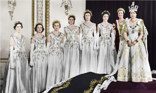  ?? ?? Clockwise from above: HM Queen Elizabeth II with her maids of honour, Buckingham Palace, 1953; George and Elizabeth holding their first child, future monarch Princess Elizabeth, in 1926; Elizabeth, Duchess of York poses in the garden of the Royal Lodge at Windsor with her daughters, Princess Elizabeth and Princess Margaret; Princess Elizabeth inspecting Auxiliary Territoria­l Service cadets; Queen Elizabeth II with dogs at Balmoral Castle in Scotland, 1952; Queen Elizabeth II with Princess Anne and her first grandchild, Peter Phillips; Royal family members at Badminton Horse Trials; Queen Elizabeth II driving Prince Charles and Princess Anne at Windsor in 1957; Queen Elizabeth II and Prince Phillip; Princess Elizabeth helping Prince Charles to climb through a window at Balmoral Castle.