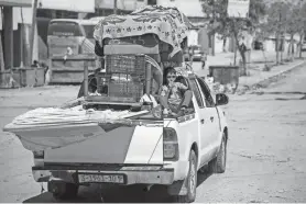  ?? HATEM KHALED/REUTERS ?? A Palestinia­n boy travels in a vehicle fleeing the southern Gaza city of Rafah Wednesday after Israeli forces launched a ground and air operation in the eastern part of the city.