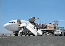 ?? PHOTOS: REUTERS ?? Workers unload aid shipment from a plane at the Sanaa airport, Yemen.