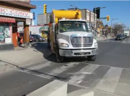  ?? JACK LAKEY/TORONTO STAR ?? Insufficie­nt turning space forces the driver of a large truck to clip the sidewalk as he turns right from southbound Old Weston Rd. to westbound St. Clair Ave. The problem: a poorly designed two-block stretch of the dedicated streetcar line along St....