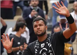  ?? MICHEL EULER — THE ASSOCIATED PRESS ?? France's Jo-Wilfried Tsonga, who retired, has a mark on his forehead after kissing the clay following his loss to Norway's Casper Ruud in the first round of the French Open.