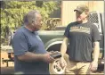  ??  ?? Reed Rankin, volunteer fire chief of Berry Creek, receives a box of cigars from James “Woody” Faircloth on Sunday Oroville.