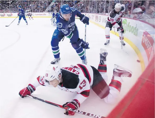  ?? — CP FILES ?? Canucks centre Brandon Sutter fights for the puck with Mike Cammalleri, one of the Devils who is past his best-before date.