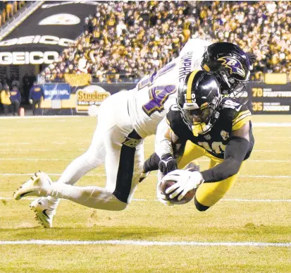  ?? DON WRIGHT/AP ?? Steelers wide receiver Diontae Johnson gets into the end zone after making a catch past Ravens cornerback Marlon Humphrey during Pittsburgh’s 20-19 win on Dec. 5. Humphrey tore a pectoral muscle as he tried to punch the ball out from Johnson near the goal line.