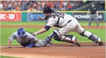  ?? GETTY IMAGES ?? Astros catcher Brian McCann tags out the Dodgers’ Austin Barnes in the sixth inning Saturday night. Game 4 ended too late for this edition. Find coverage at jsonline.com/brewers.