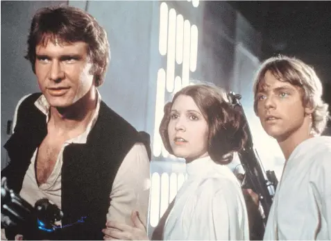  ?? 20TH CENTURY-FOX ?? Harrison Ford, left, Carrie Fisher and Mark Hamill appear in a scene from the original Star Wars.