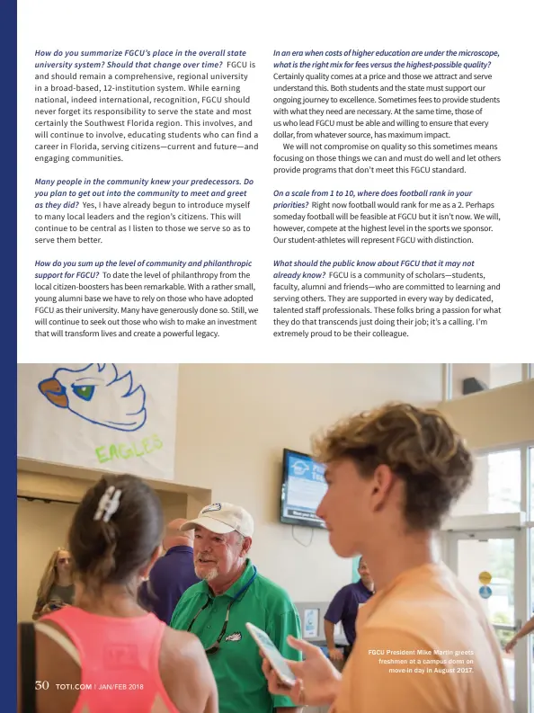  ??  ?? FGCU President Mike Martin greets freshmen at a campus dorm on move-in day in August 2017.