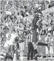  ?? DAVID STEPHENSON/AP ?? Kentucky wide receiver Blake Bone catches a TD over Florida defensive back Nick Washington. The game was not complete in time for this edition. SunSentine­l.com/sports