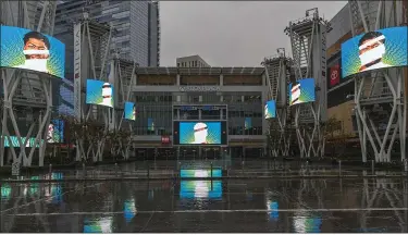  ?? DAMIAN DOVARGANES — THE ASSOCIATED PRESS ?? Video screens show images of Lakers’ Anthony Davis in a plaza across from Staples Center on March 12.