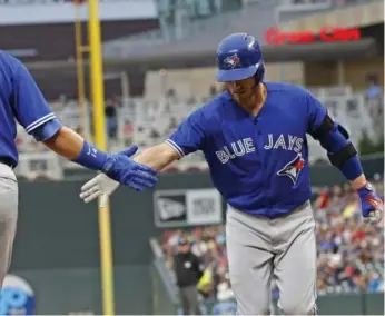  ?? JIM MONE/THE ASSOCIATED PRESS ?? The Jays’ Josh Donaldson heads for home after crushing the first pitch he saw into the second deck at Target Field.