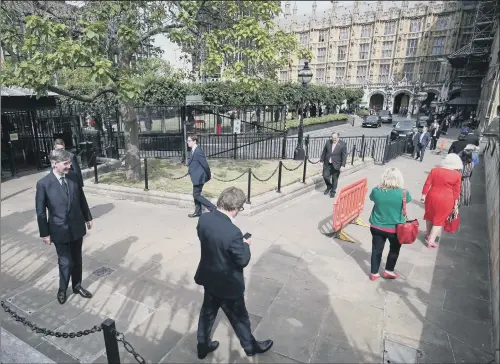  ?? PICTURE: JONATHAN BRADY/PA ?? SOCIALLY DISTANCED: Members of Parliament, including Leader of the House of Commons Jacob Rees-Mogg, queue outside the House of Commons.