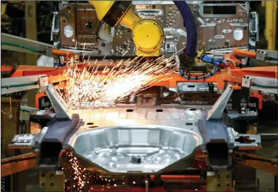  ?? (AP/Amr Alfiky) ?? Robots work on an assembly line at a Ford plant in Chicago last year. Across the manufactur­ing sector, production, new orders, hiring and export orders all fell faster in April than they did in March, a report said Friday.