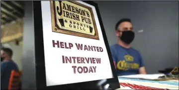  ?? ASSOCIATED PRESS ?? A hiring sign is placed at a booth for Jameson’s Irish Pub during a job fair, Sept. 22, in West Hollywood.