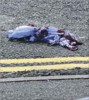  ??  ?? Police seal off the area as a blood-stained cloth marks the spot where the fight took place near the junction of Christchur­ch Road and Beaver Road