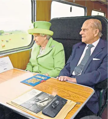  ??  ?? The Queen and the Duke of Edinburgh travel by steam train along Northern Ireland’s coast from Coleraine to Bellarena. When asked if she was well at a dinner by Deputy First Minister Martin McGuinness, Her Majesty replied: “Thank you very much – I’m...