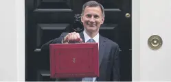  ?? ?? Chancellor Jeremy Hunt leaves Downing Street with the despatch box to present his Spring Budget to Parliament on March 15, 2023. Photo by Carl Court/Getty Images
