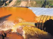  ?? BRENNAN LINSLEY/ASSOCIATED PRESS ?? Water flows through a series of sediment retention ponds built to reduce heavy metal and chemical contaminan­ts from the Gold King Mine in August 2015.