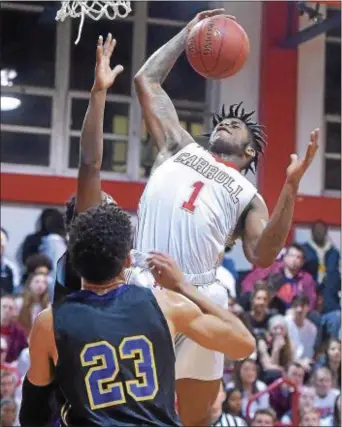  ?? PETE BANNAN — DIGITAL FIRST MEDIA ?? Archbishop Carroll’s Keyon Butler (1) puts up a shot in the first half against Roman Catholic Friday night. The Patriots came up on the short end of a 70-66 score.