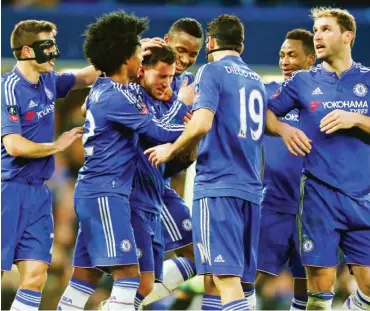  ??  ?? Chelsea players celebrate with goalscorer Eden Hazard in last season’s English Premier Leaque